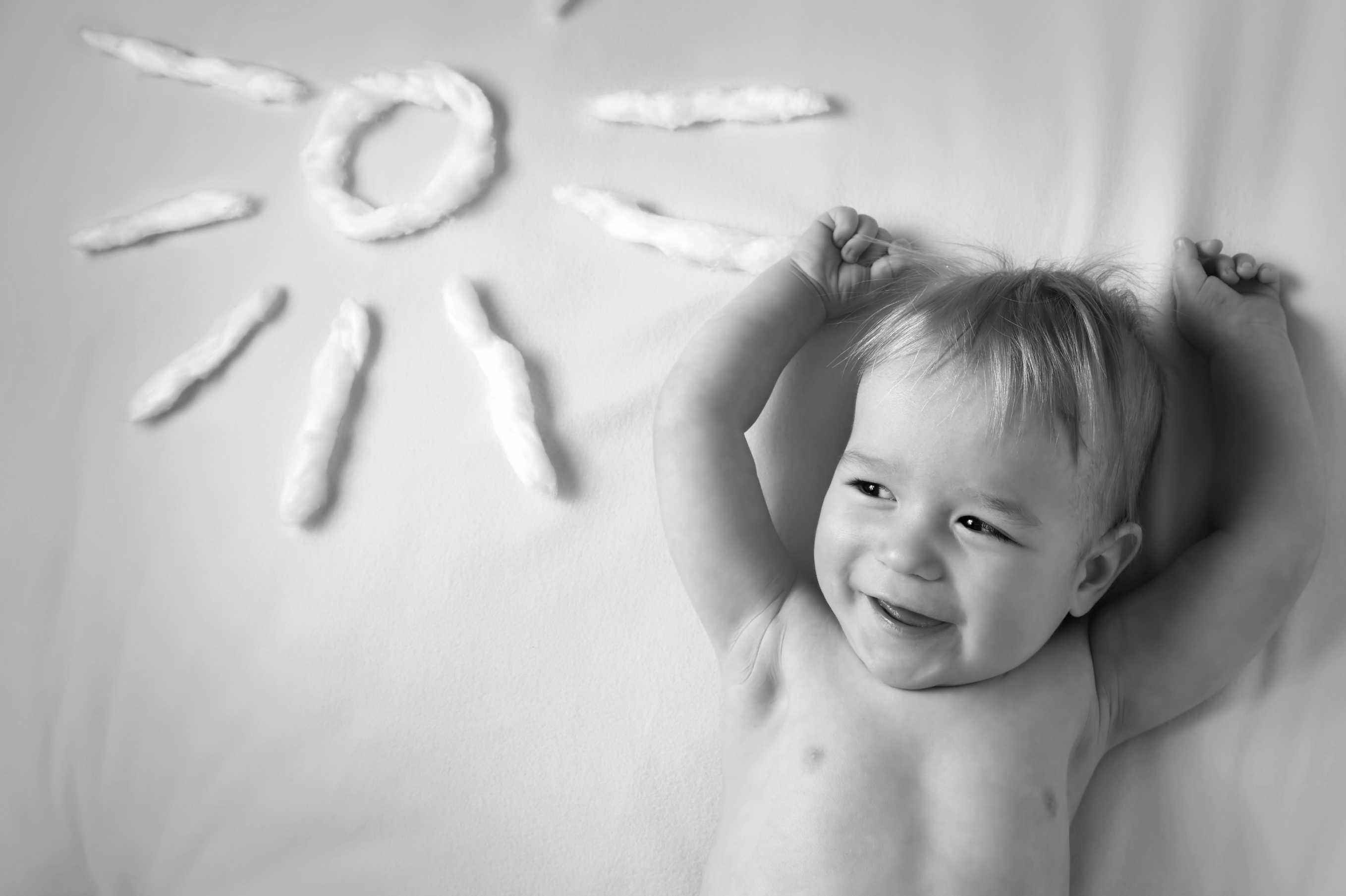 little boy with sunglasses and sun shape on yellow blanket